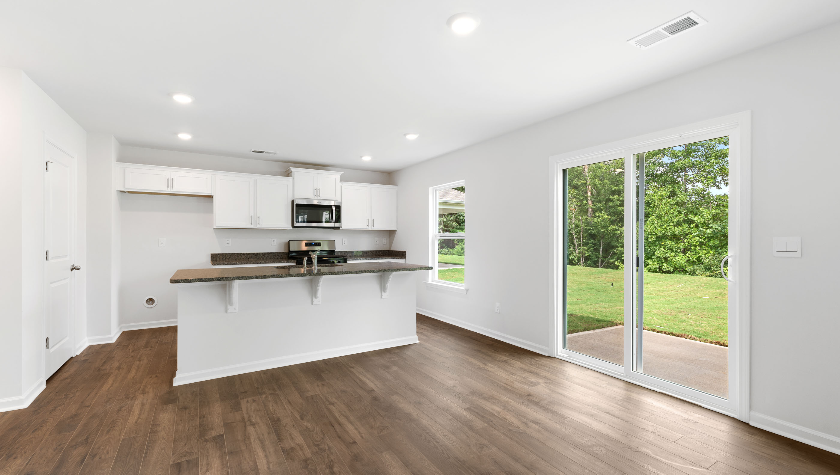 Kitchen and island with door to back yard.