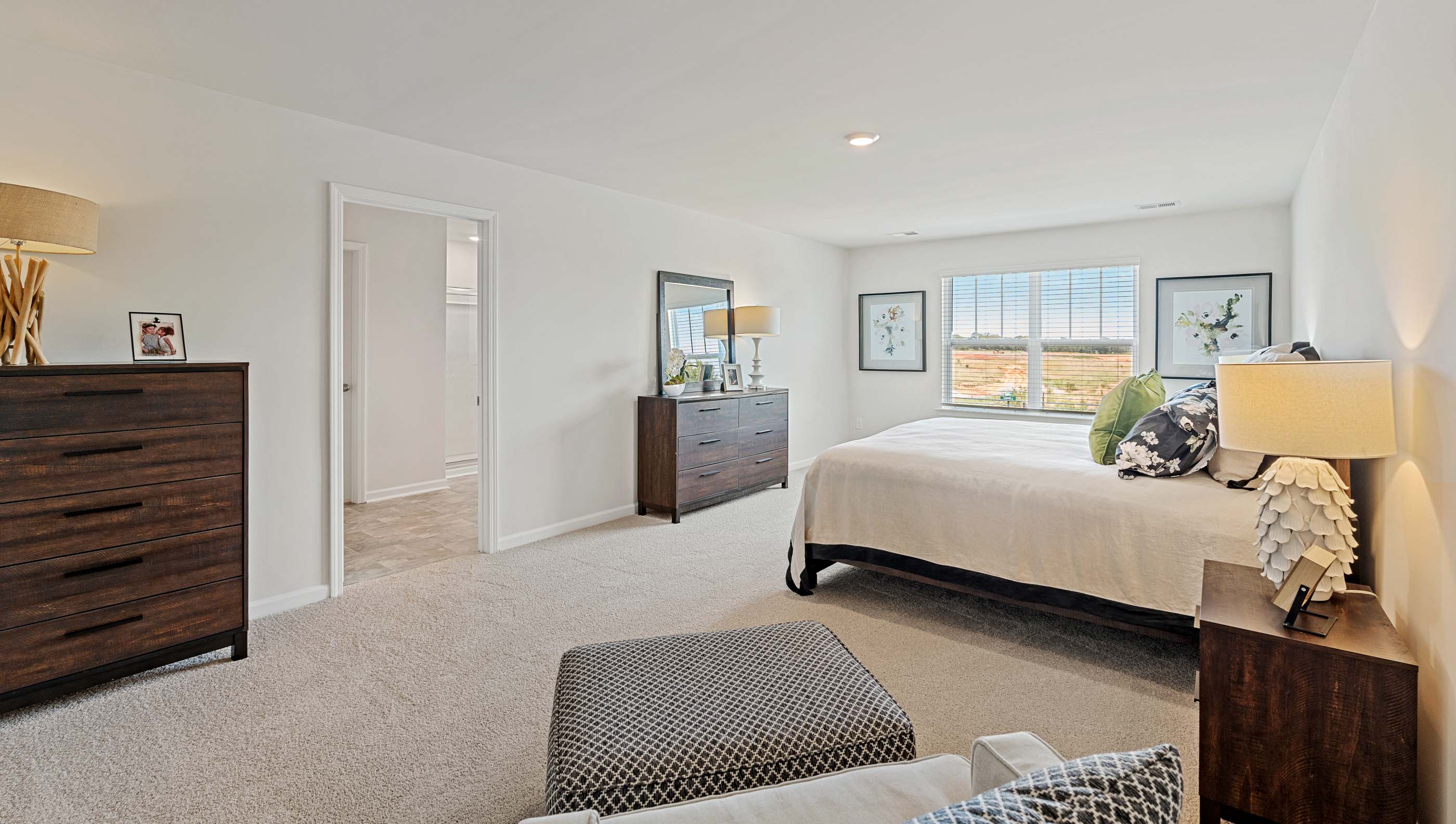 Bedroom with carpet and windows.