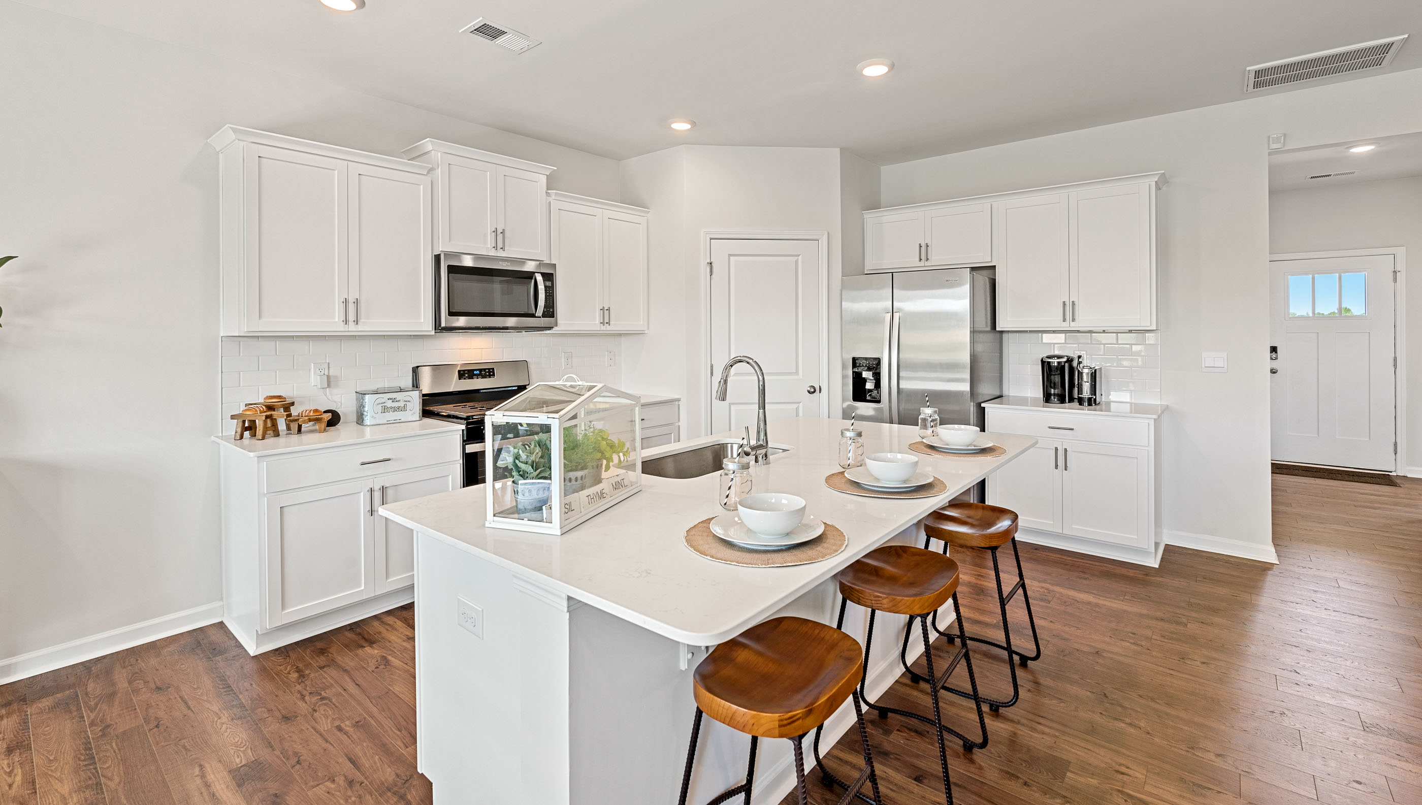 Kitchen and island with granite counter tops.