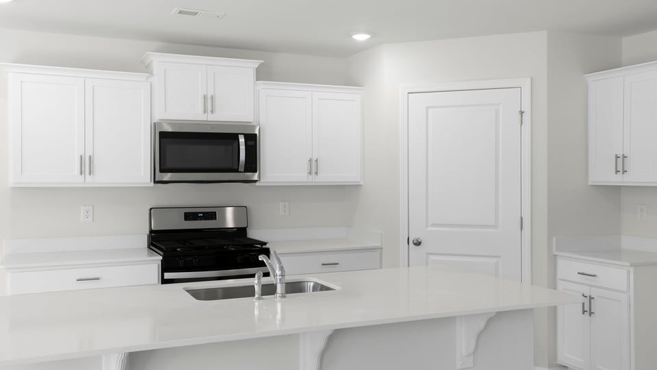 Kitchen with island and countertops.
