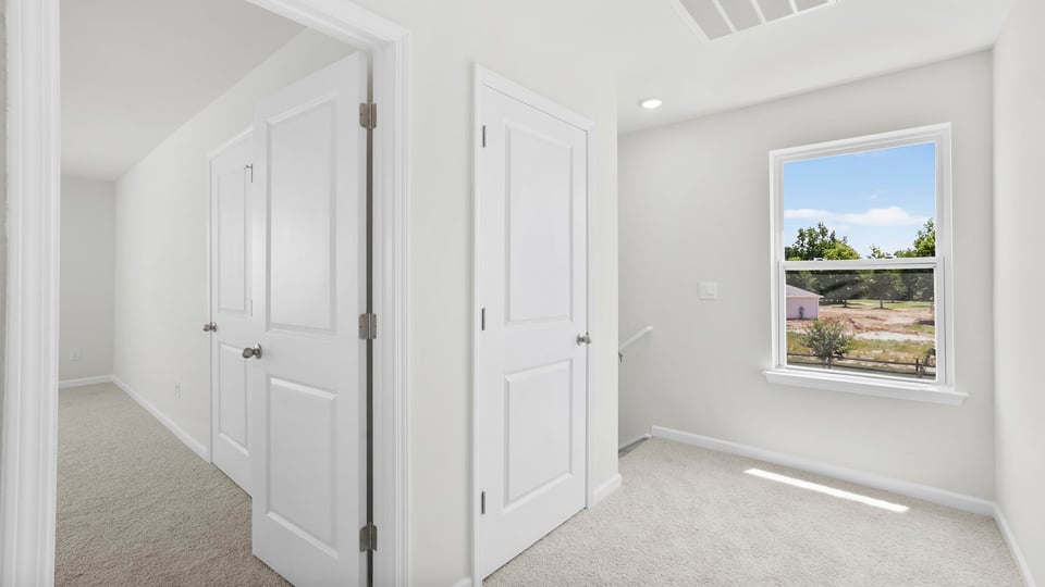 Bedroom with carpet and windows.