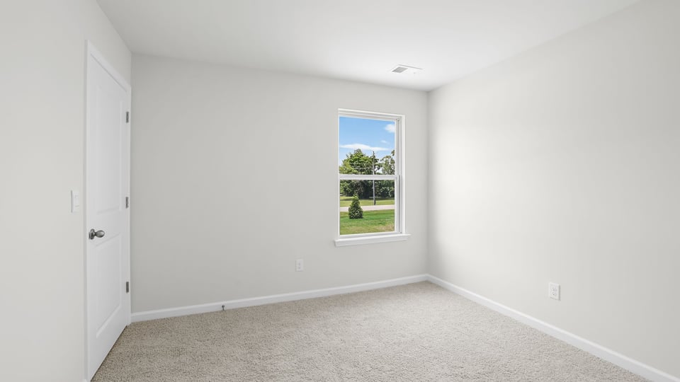 Bedroom with carpet and windows.