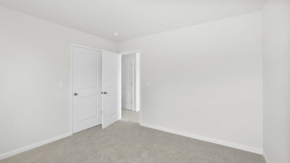 Bedroom with carpet and windows.