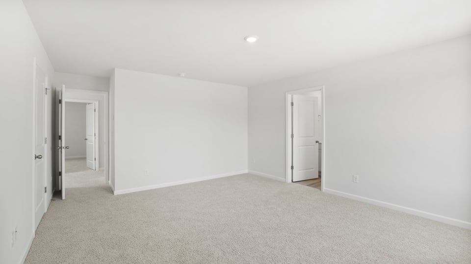 Bedroom with carpet and windows.