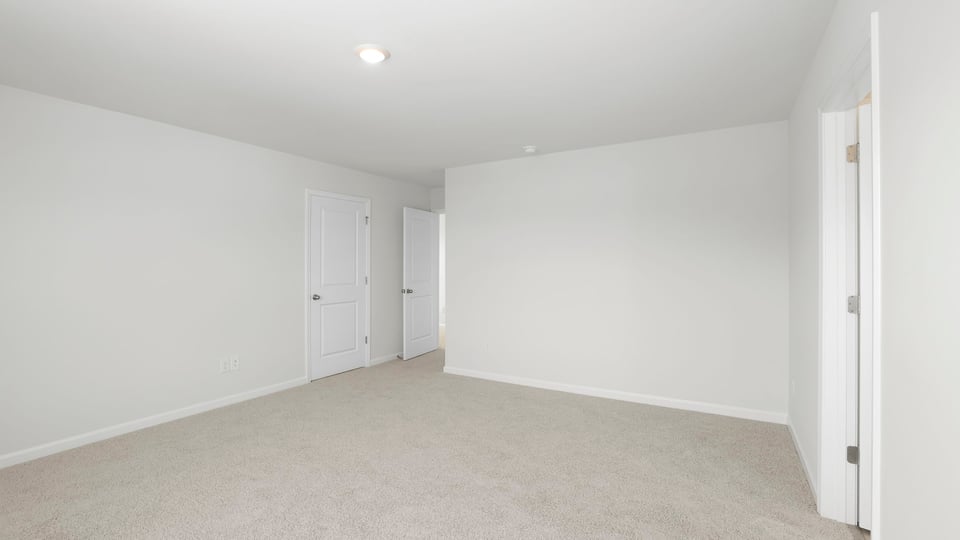 Bedroom with carpet and windows.