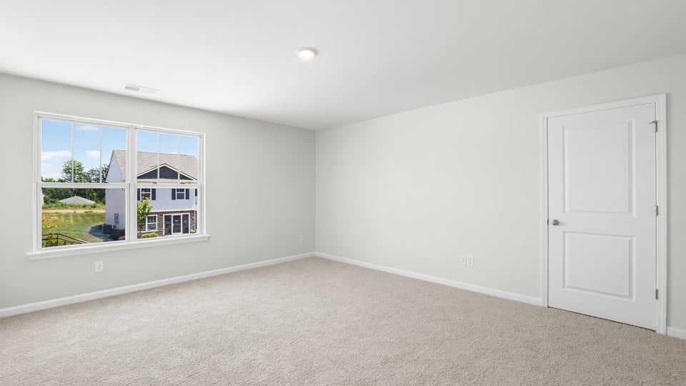 Bedroom with carpet and windows.