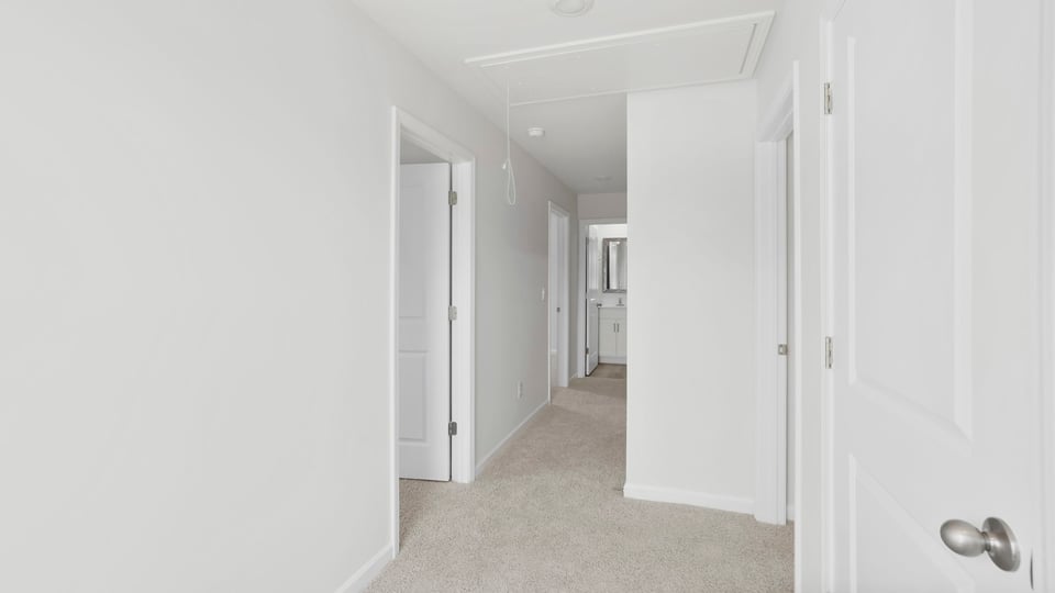 Bedroom with carpet and windows.