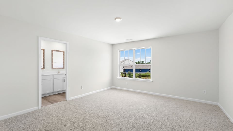 Bedroom with carpet and windows.
