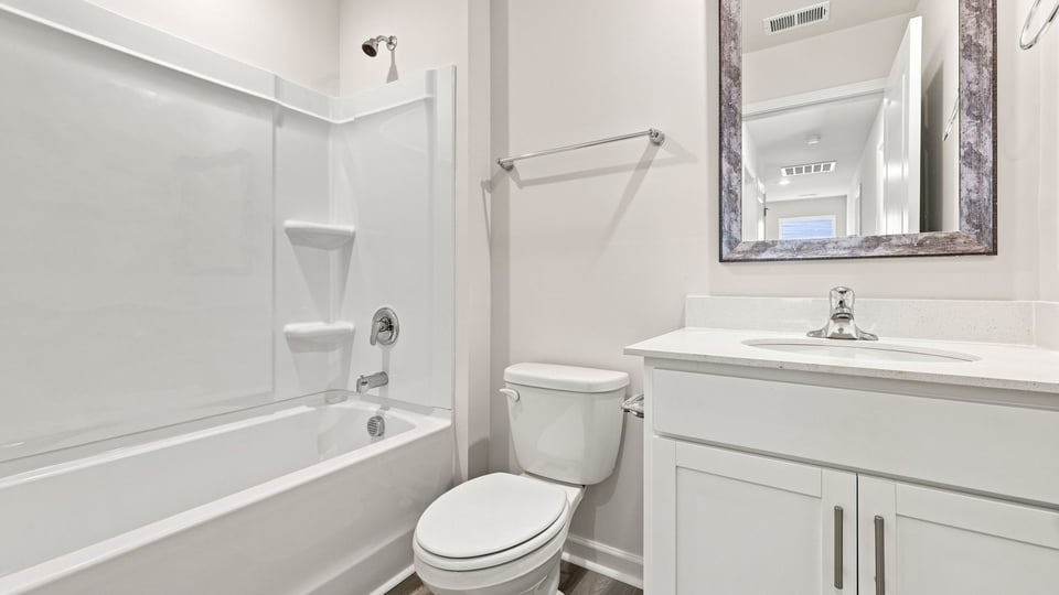 Hall bathroom with vanity and combination shower / tub.