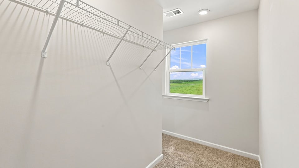 Primary bedroom walk-in closet.