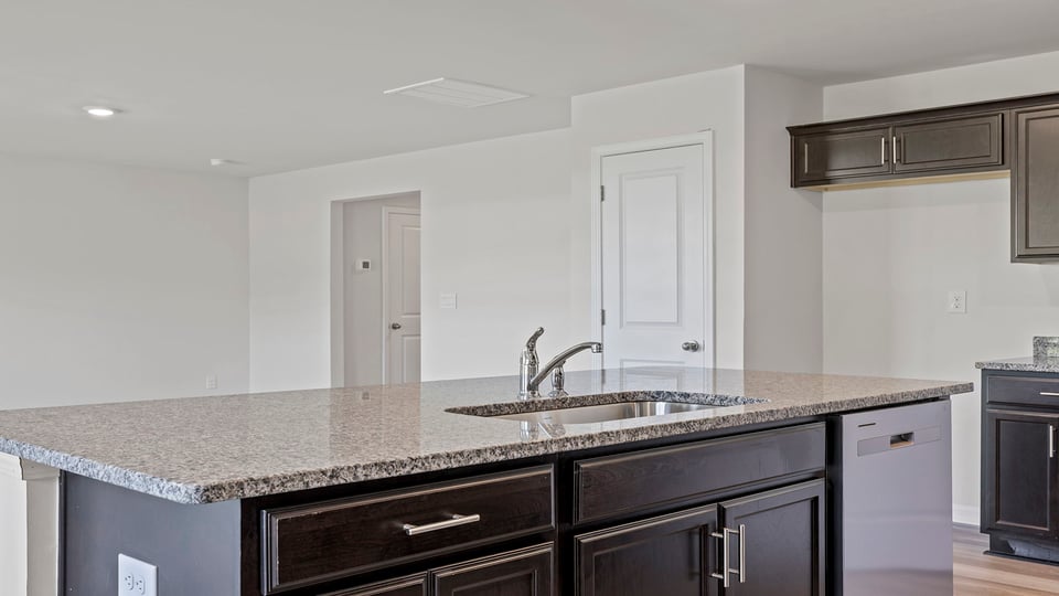 Kitchen and island with granite countertops.