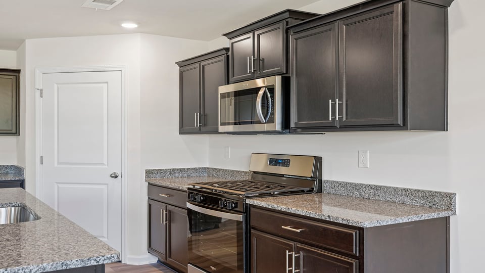 Kitchen with granite countertops and stainless steel appliances.