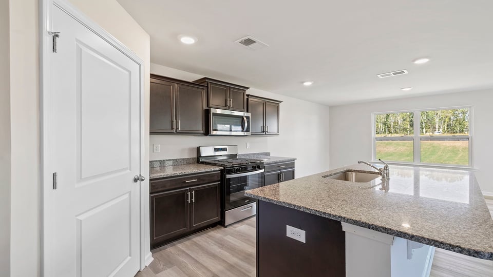 Kitchen and island with granite countertops.