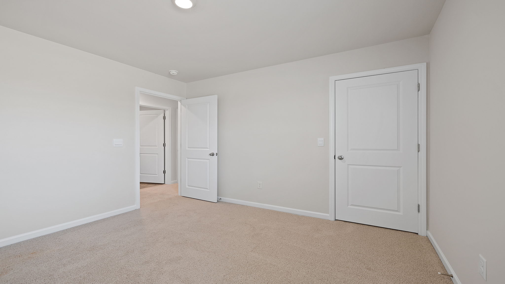 Bedroom with carpet and window.