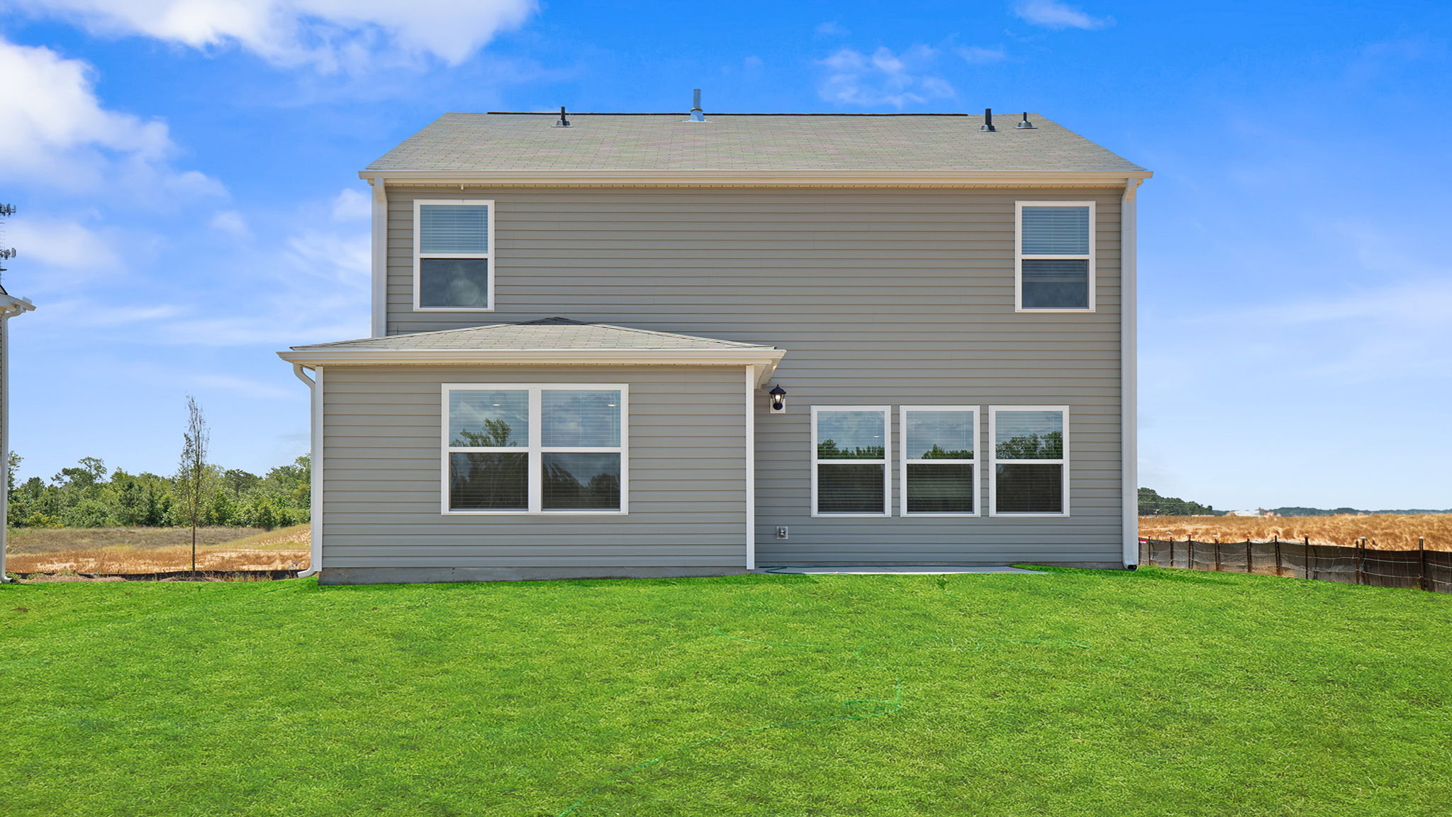 Exterior of home with large backyard.