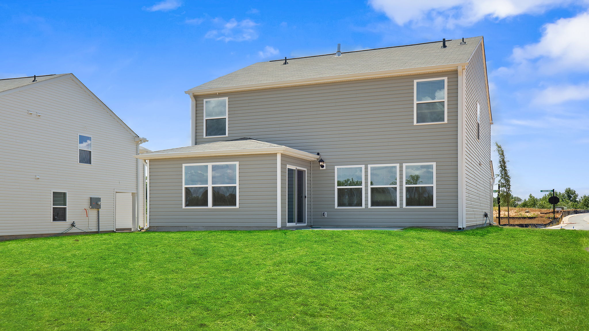 Exterior of home with large backyard.