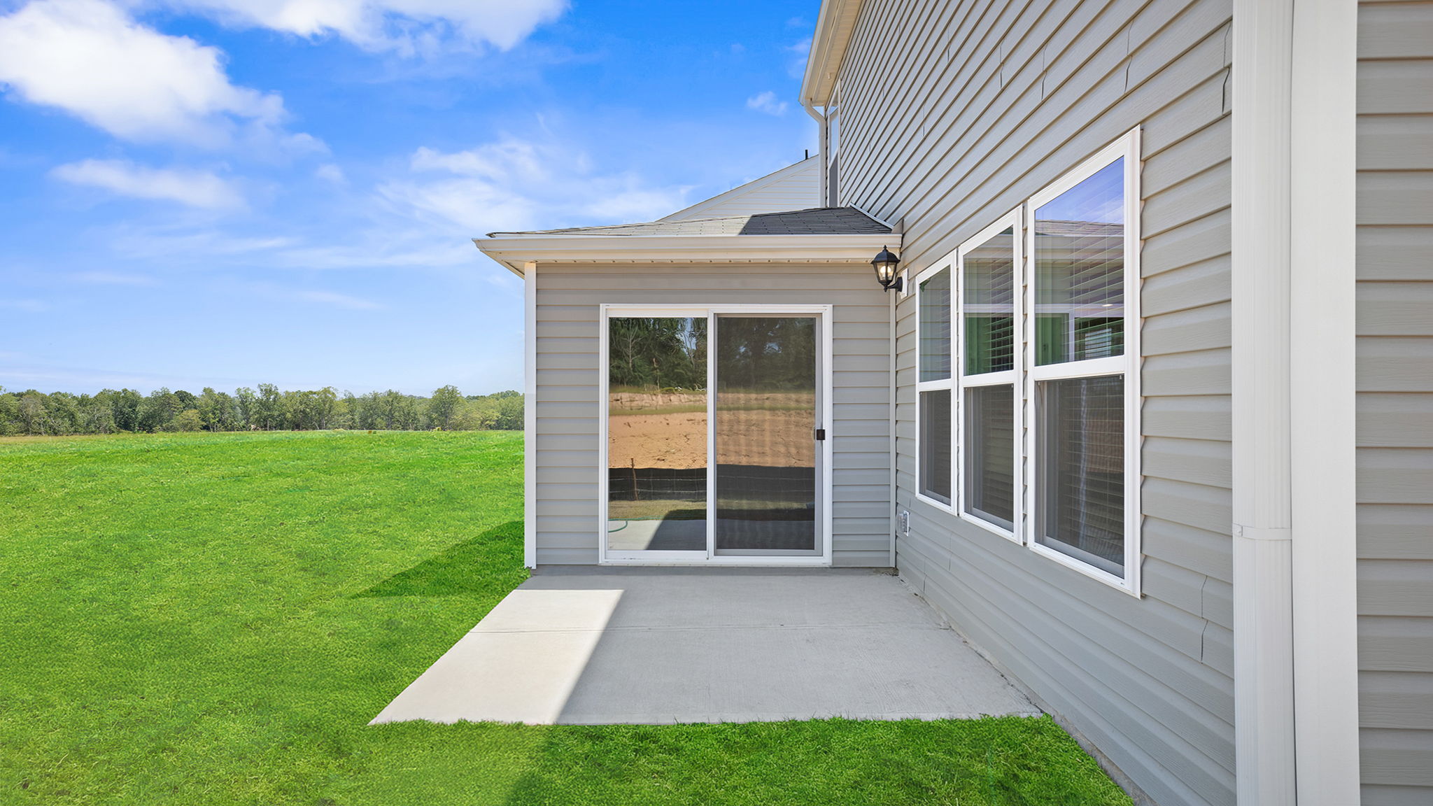 Exterior of home with large backyard.