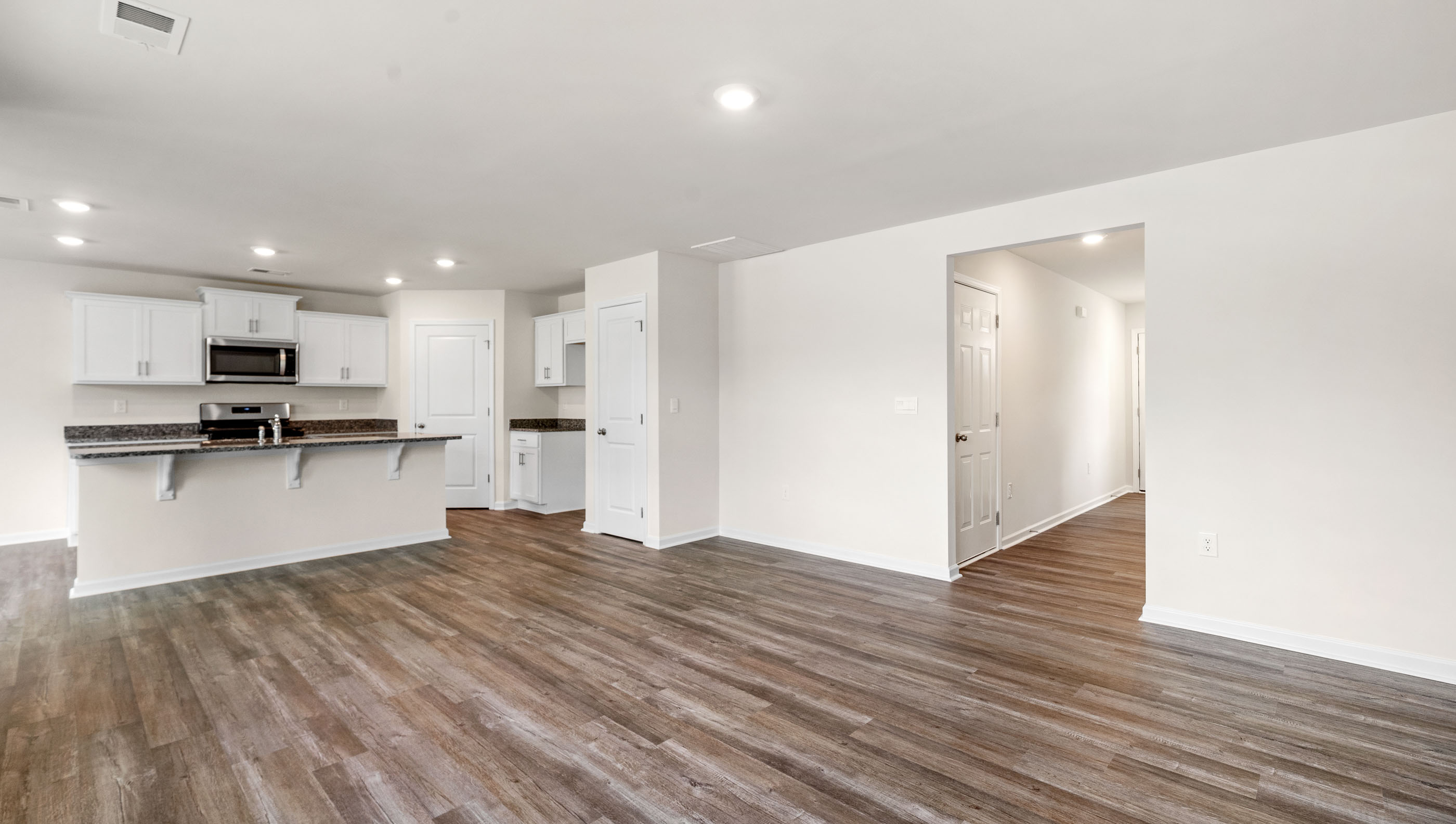 Living room with view of kitchen.