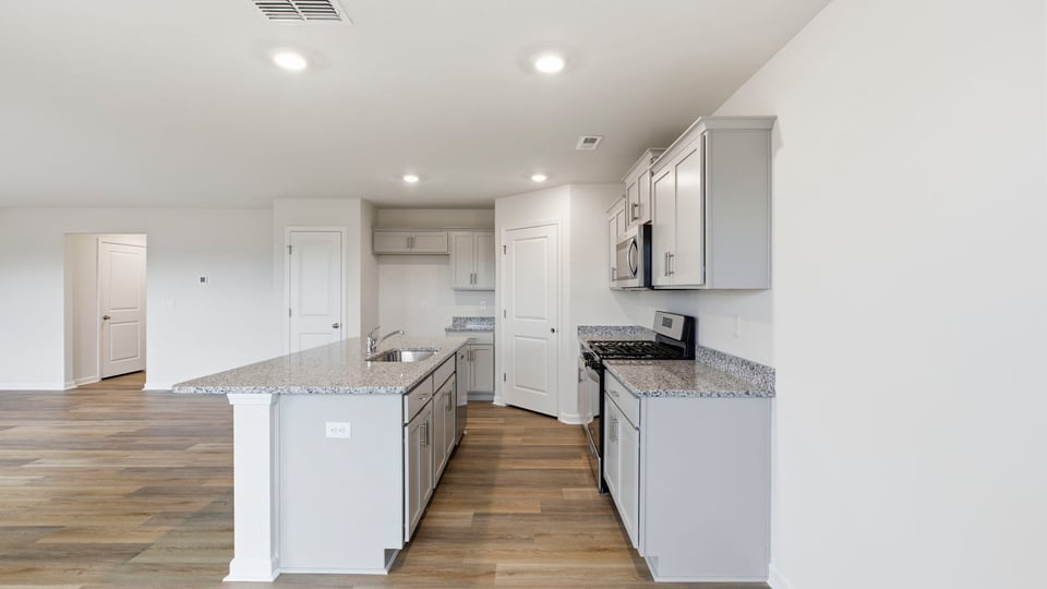 Kitchen and island with granite counter tops.