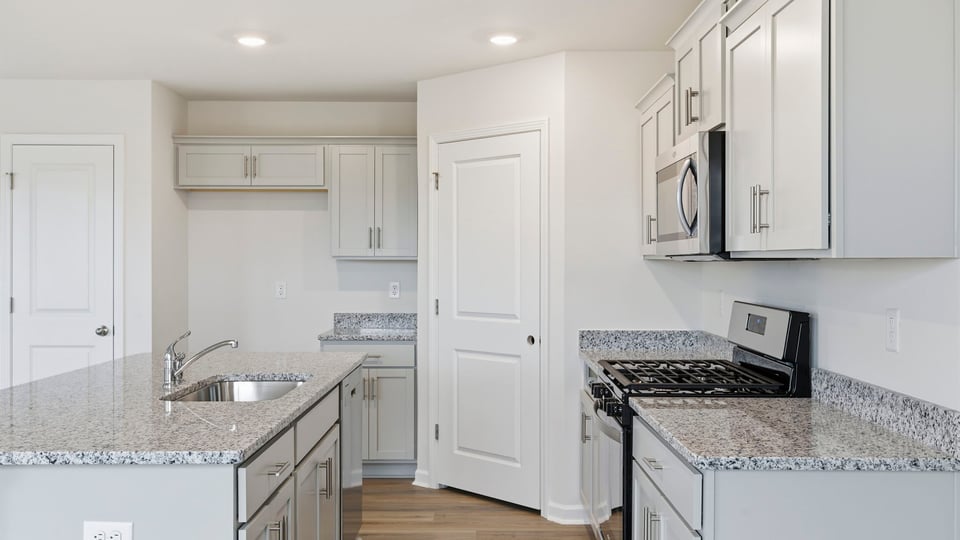 Kitchen and island with granite counter tops.