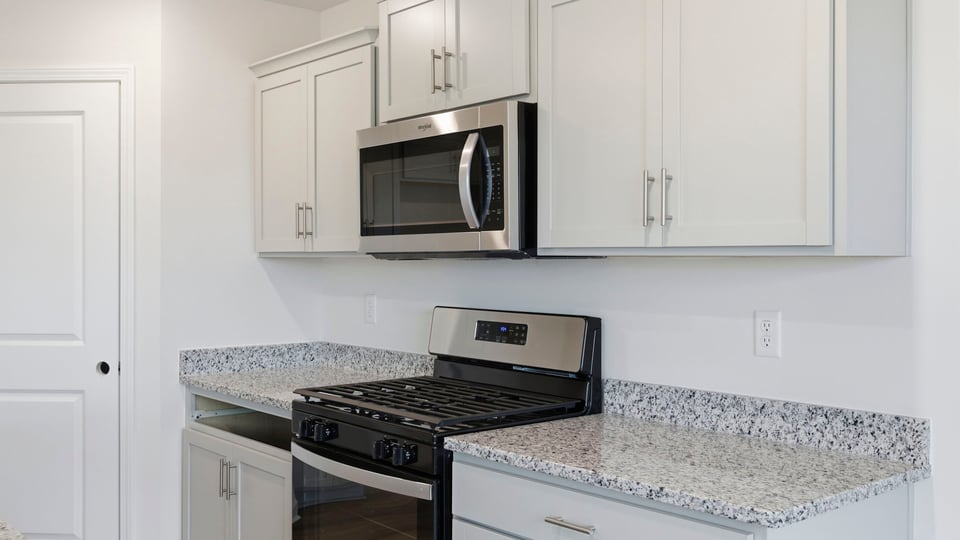 Kitchen and island with granite counter tops.