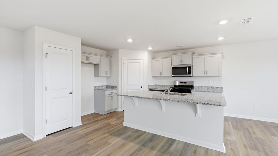 Kitchen and island with granite counter tops.