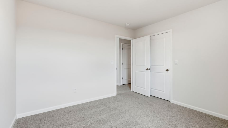 Bedroom with carpet and window.