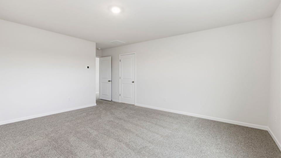 Bedroom with carpet and window.