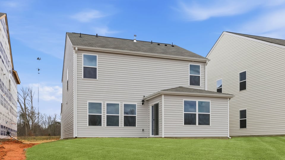 Exterior of home with large backyard.