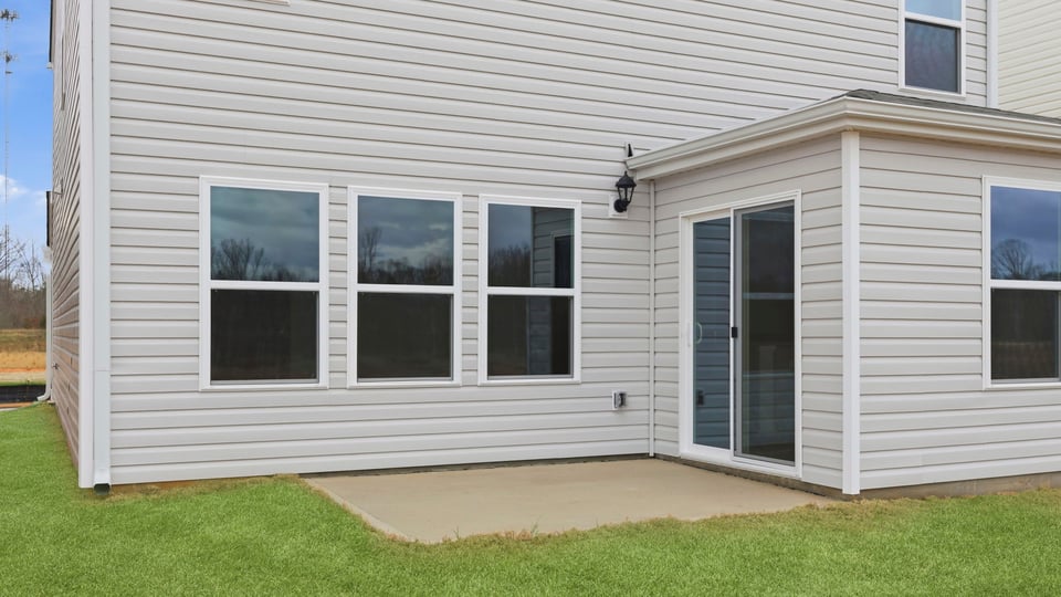 Exterior of home with large backyard.