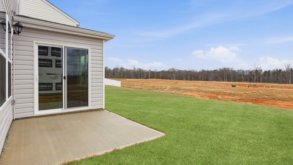 Exterior of home with large backyard.