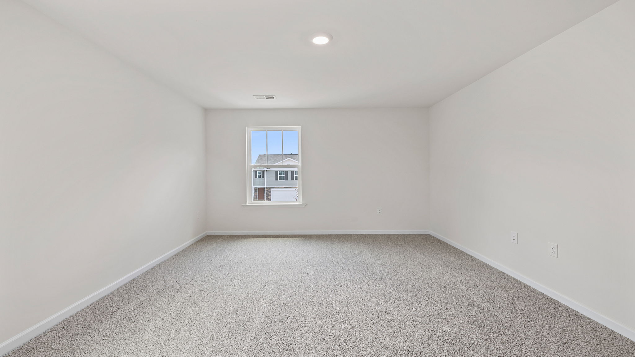 Bedroom with carpet and windows.