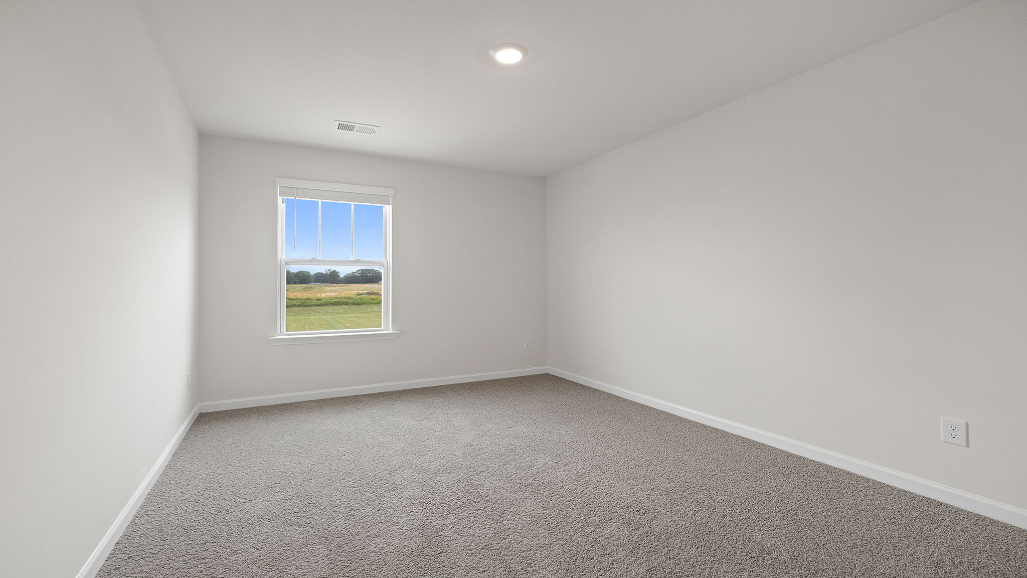 Bedroom with carpet and window.