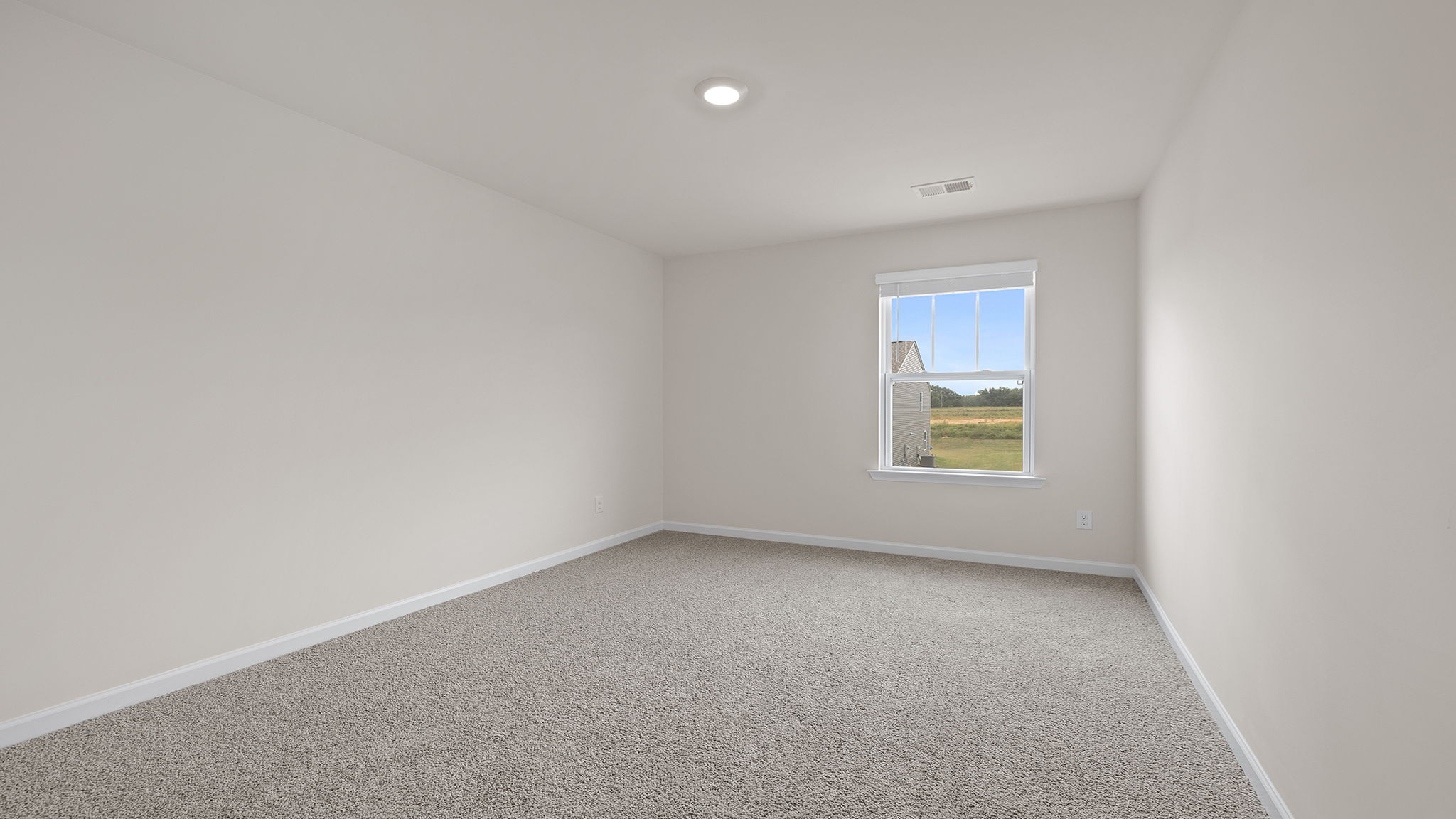 Bedroom with carpet and window.