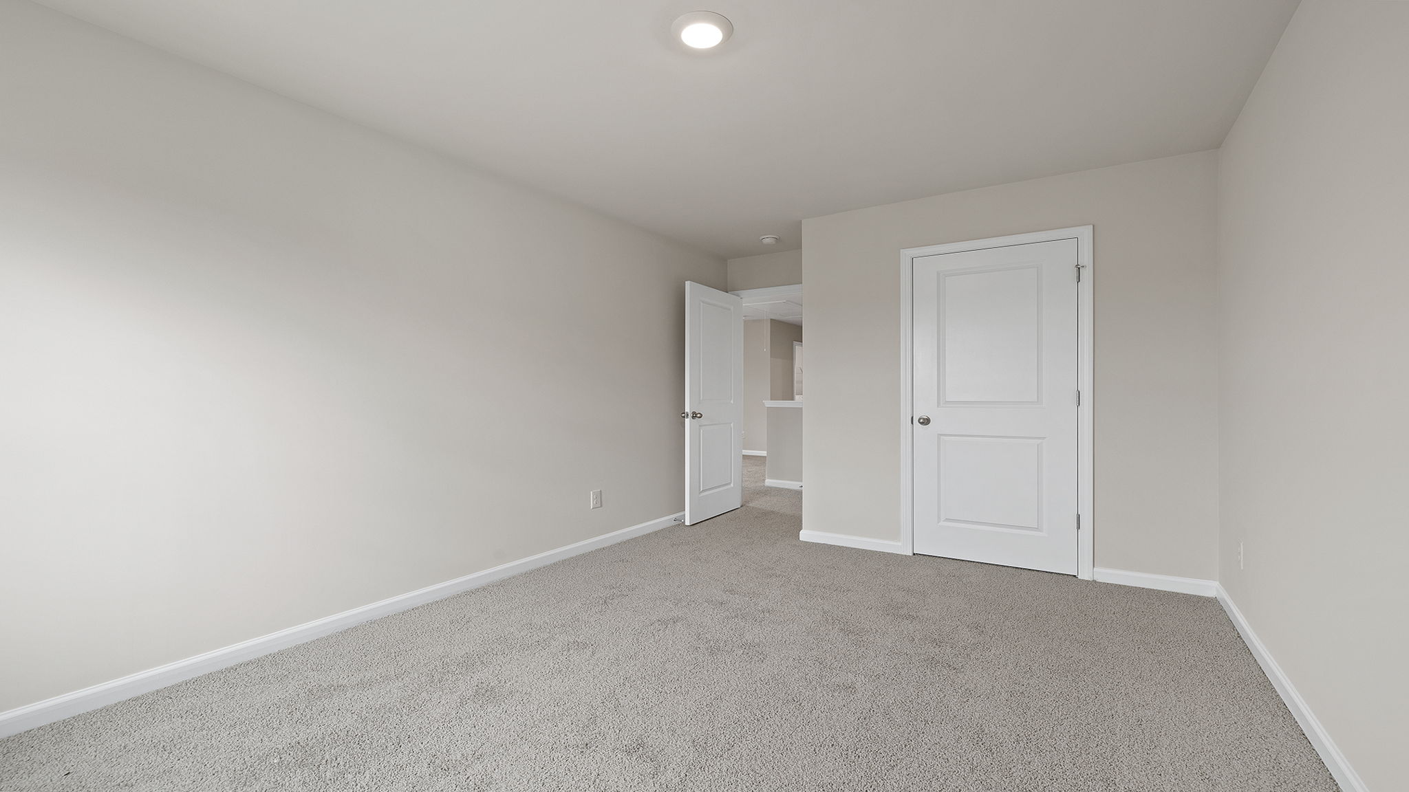 Bedroom with carpet and window.