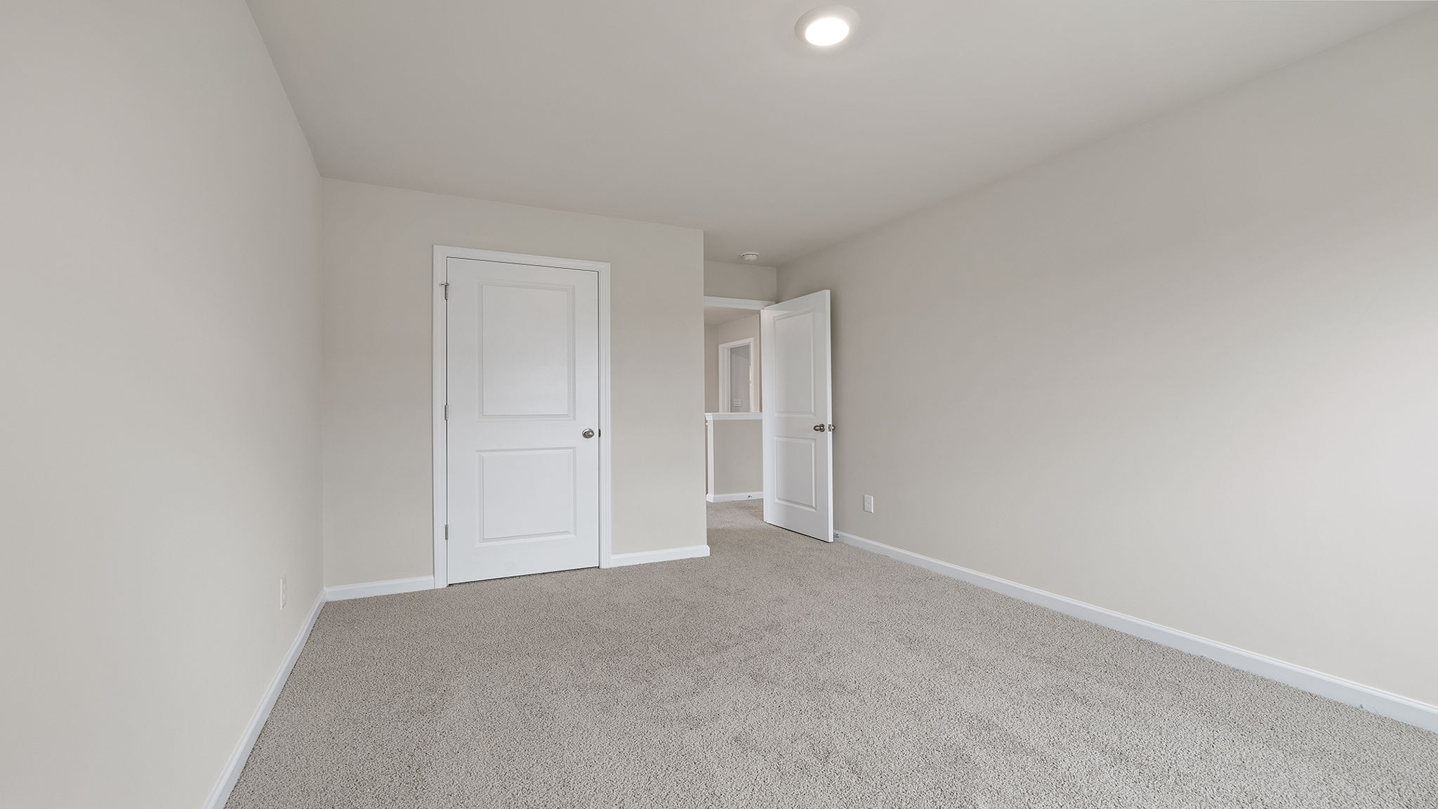 Bedroom with carpet and window.