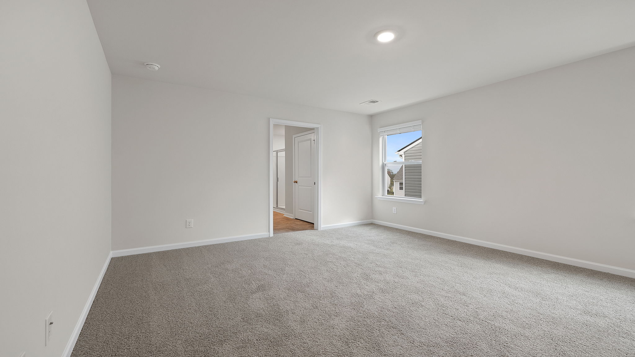 Bedroom with carpet and window.