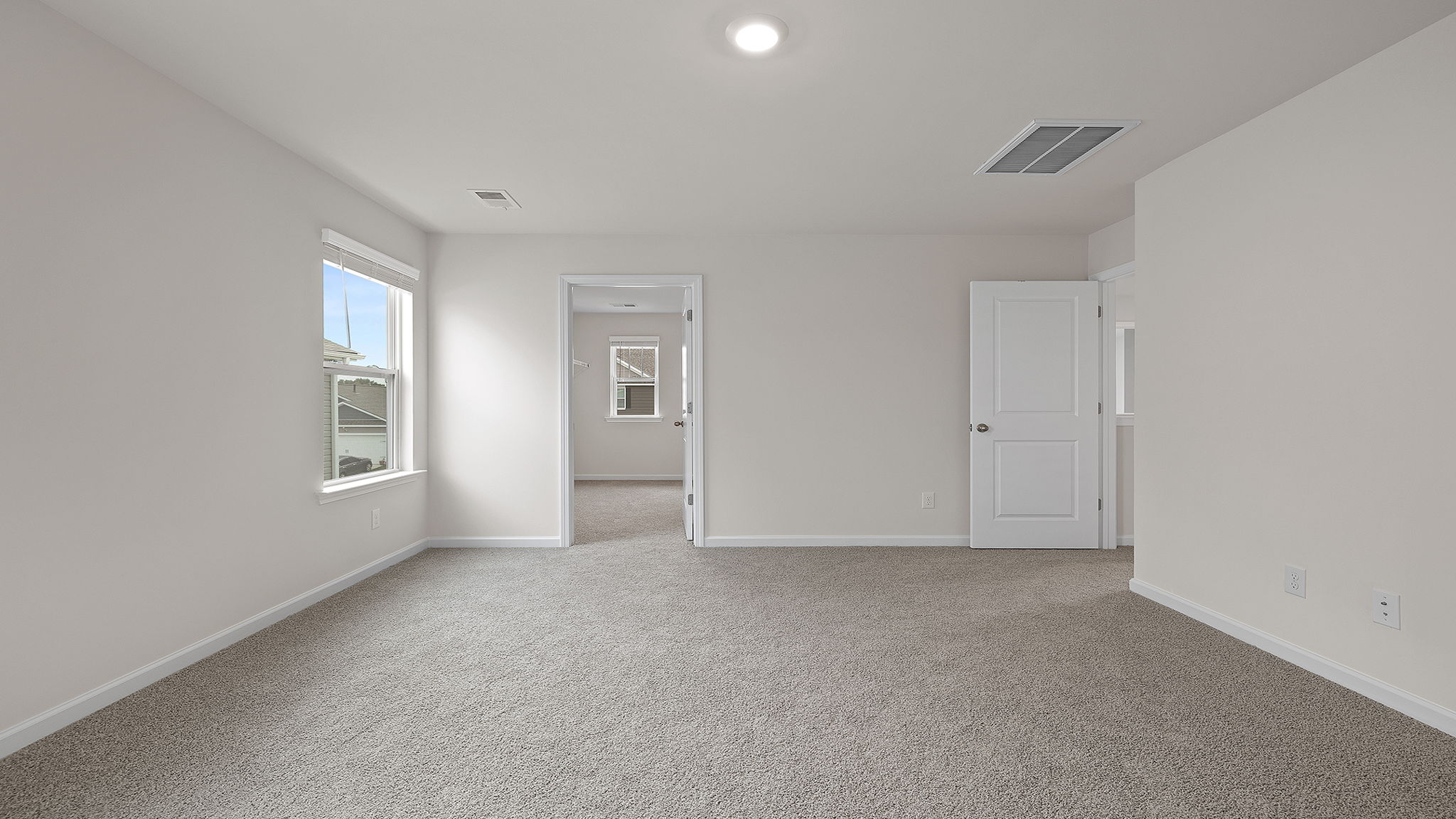 Bedroom with carpet and window.