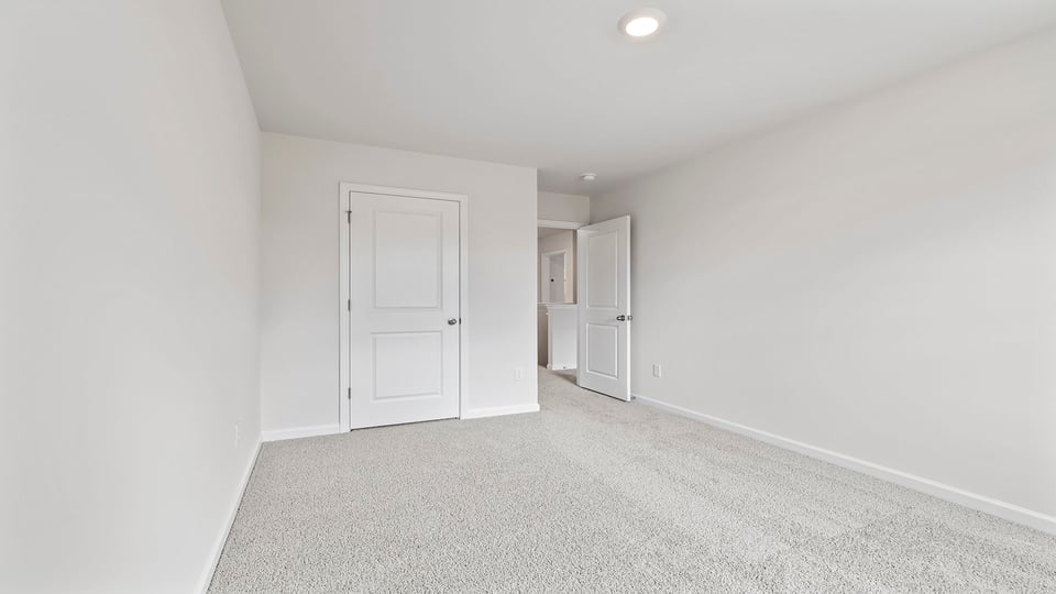 Bedroom with carpet and windows.