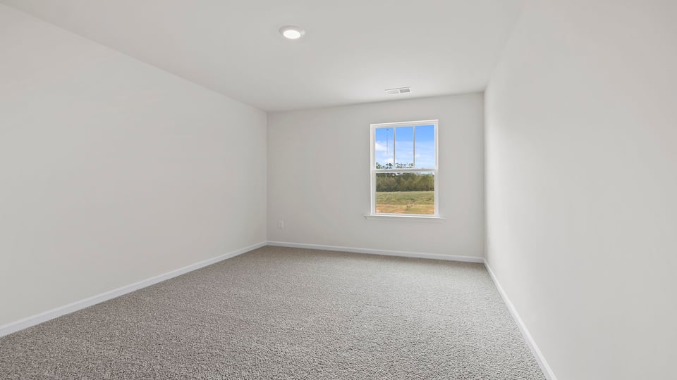 Bedroom with carpet and windows.