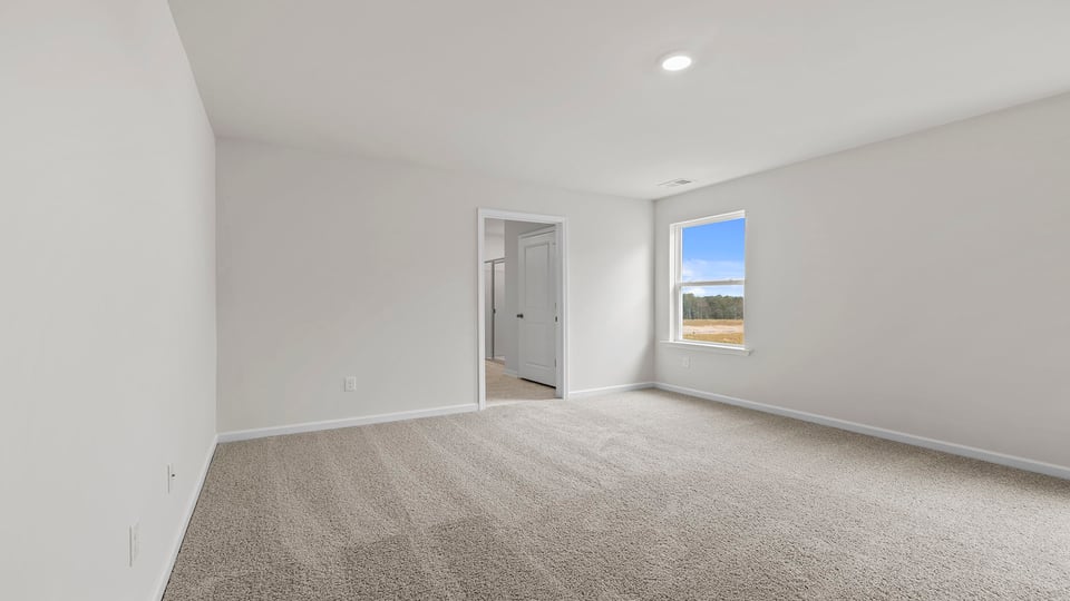 Bedroom with carpet and windows.