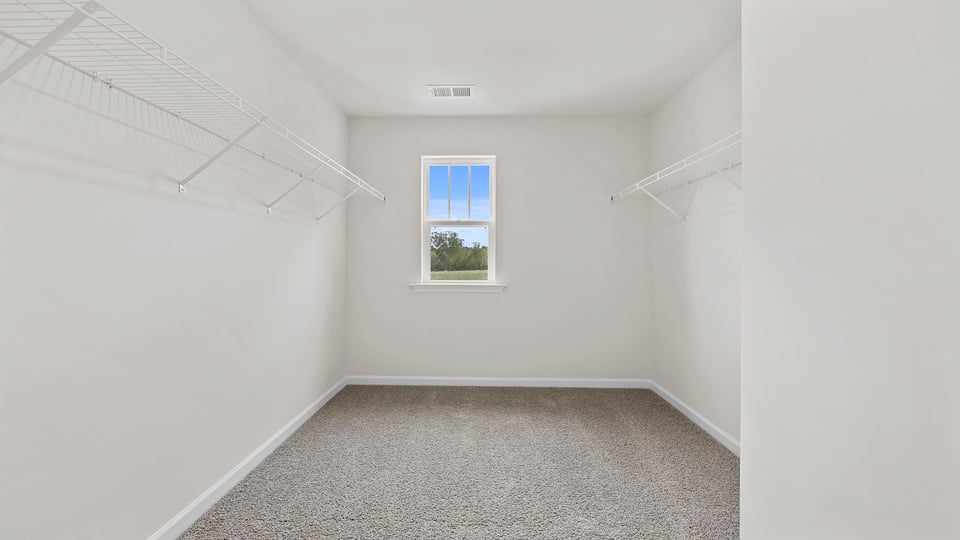 Bedroom with carpet and windows.