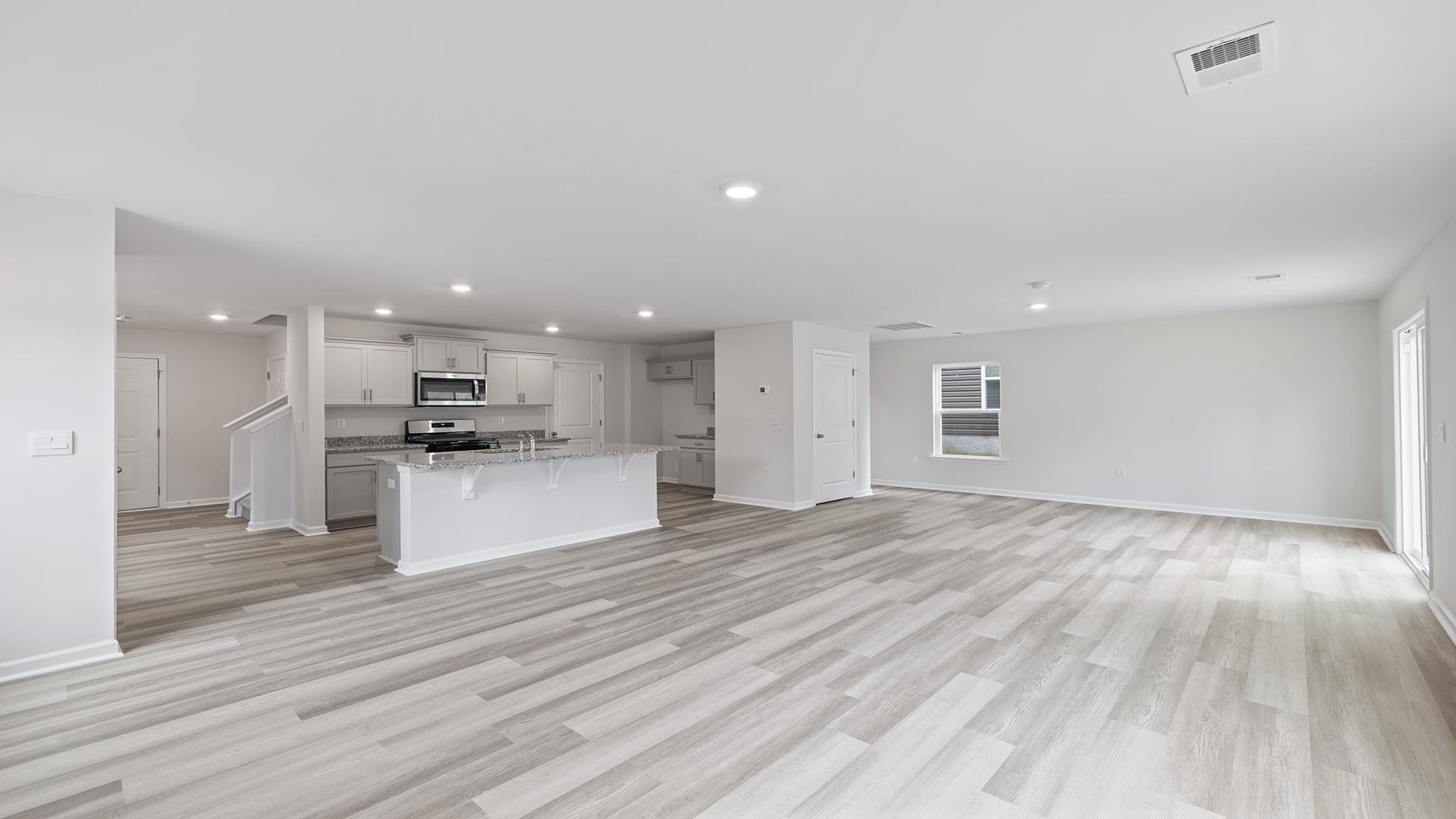 Living room and dining room area with windows.