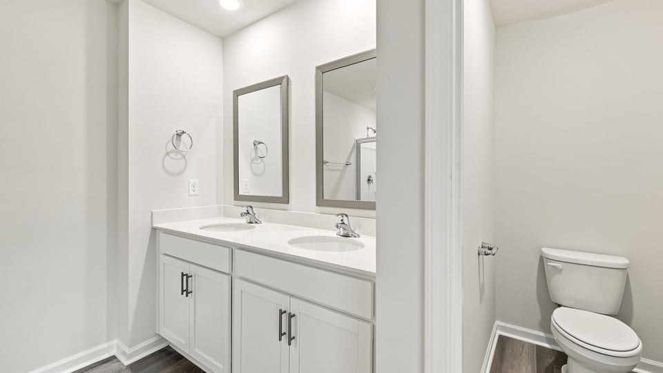 Bathroom with double vanity and tub.