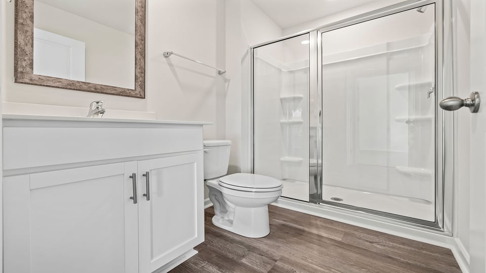 Bathroom with vanity and walk in shower.