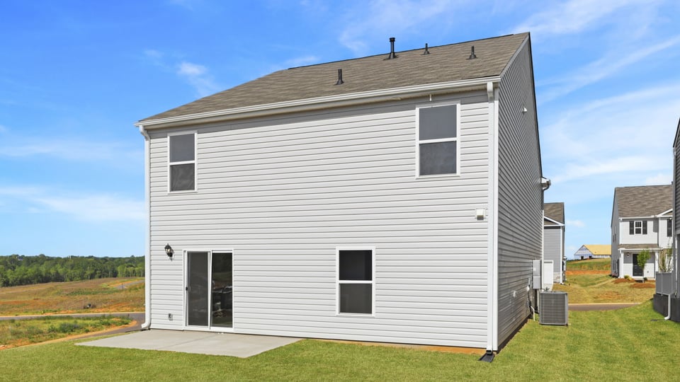 Exterior of home with large backyard.