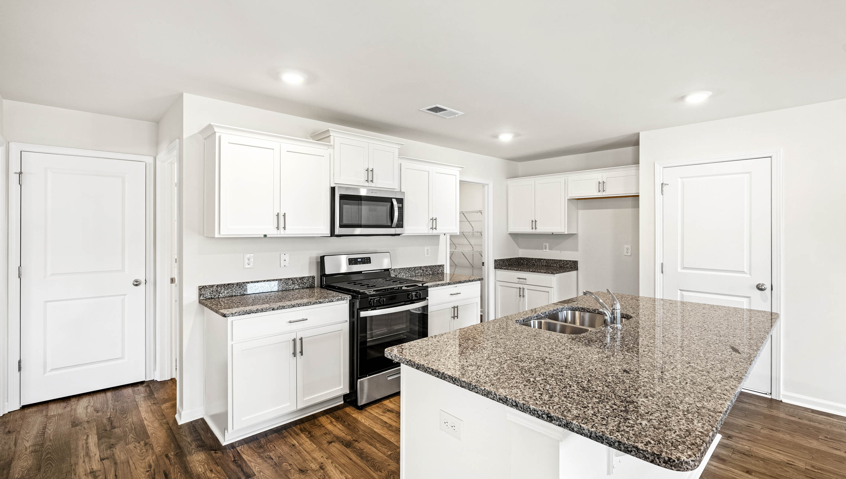 Kitchen and island with granite countertops.