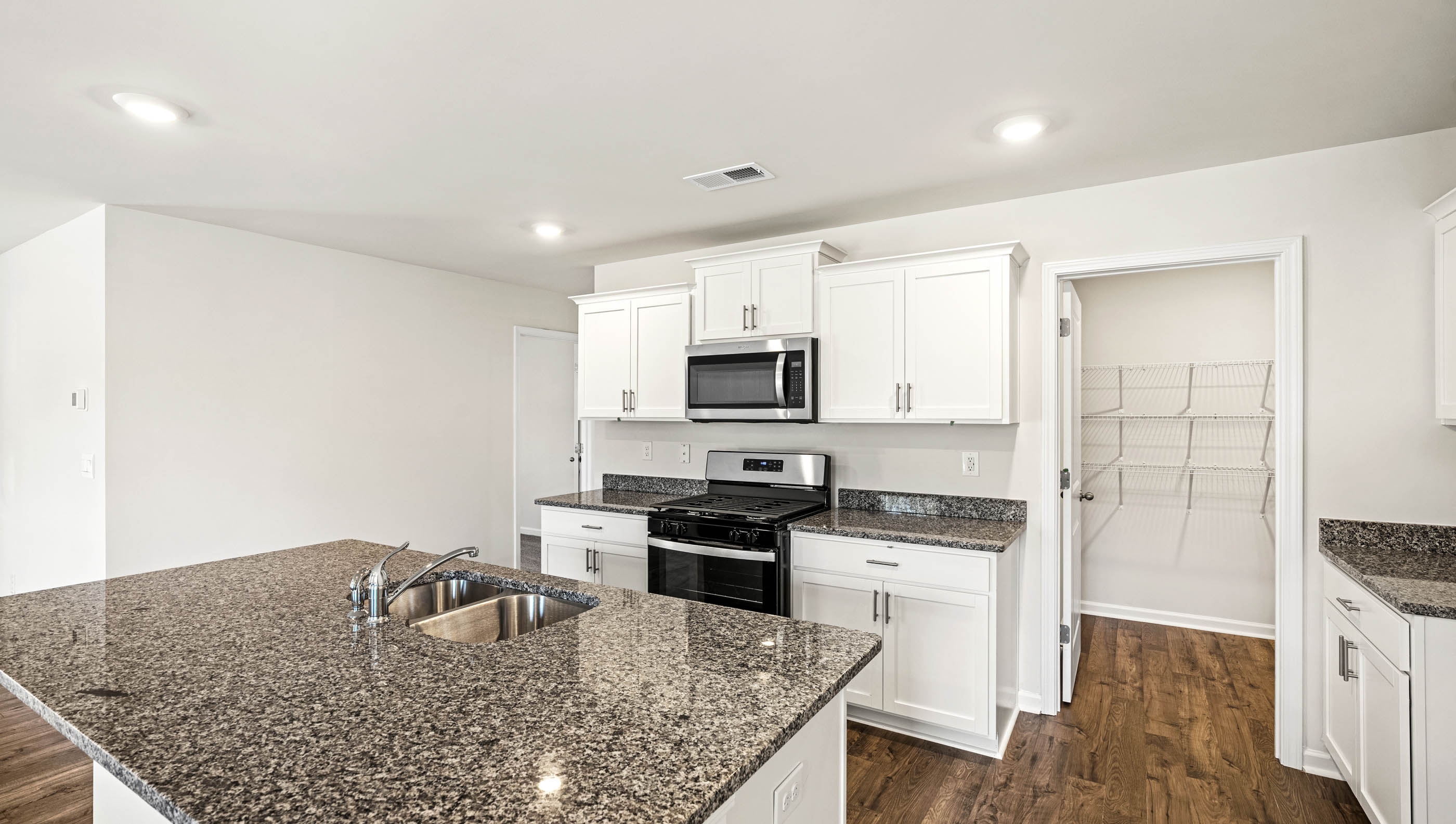 Kitchen and island with granite countertops.
