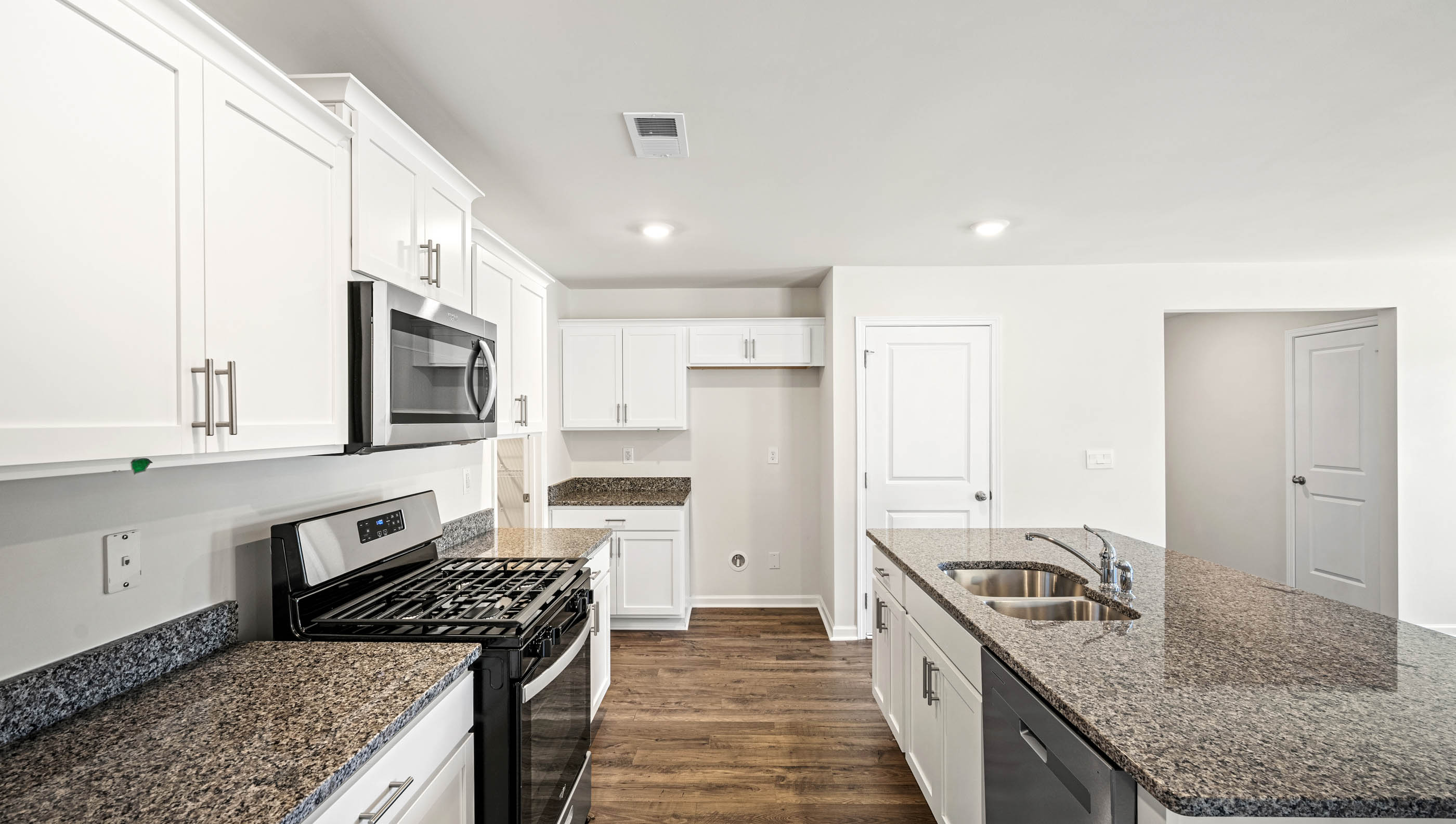 Kitchen and island with granite countertops.