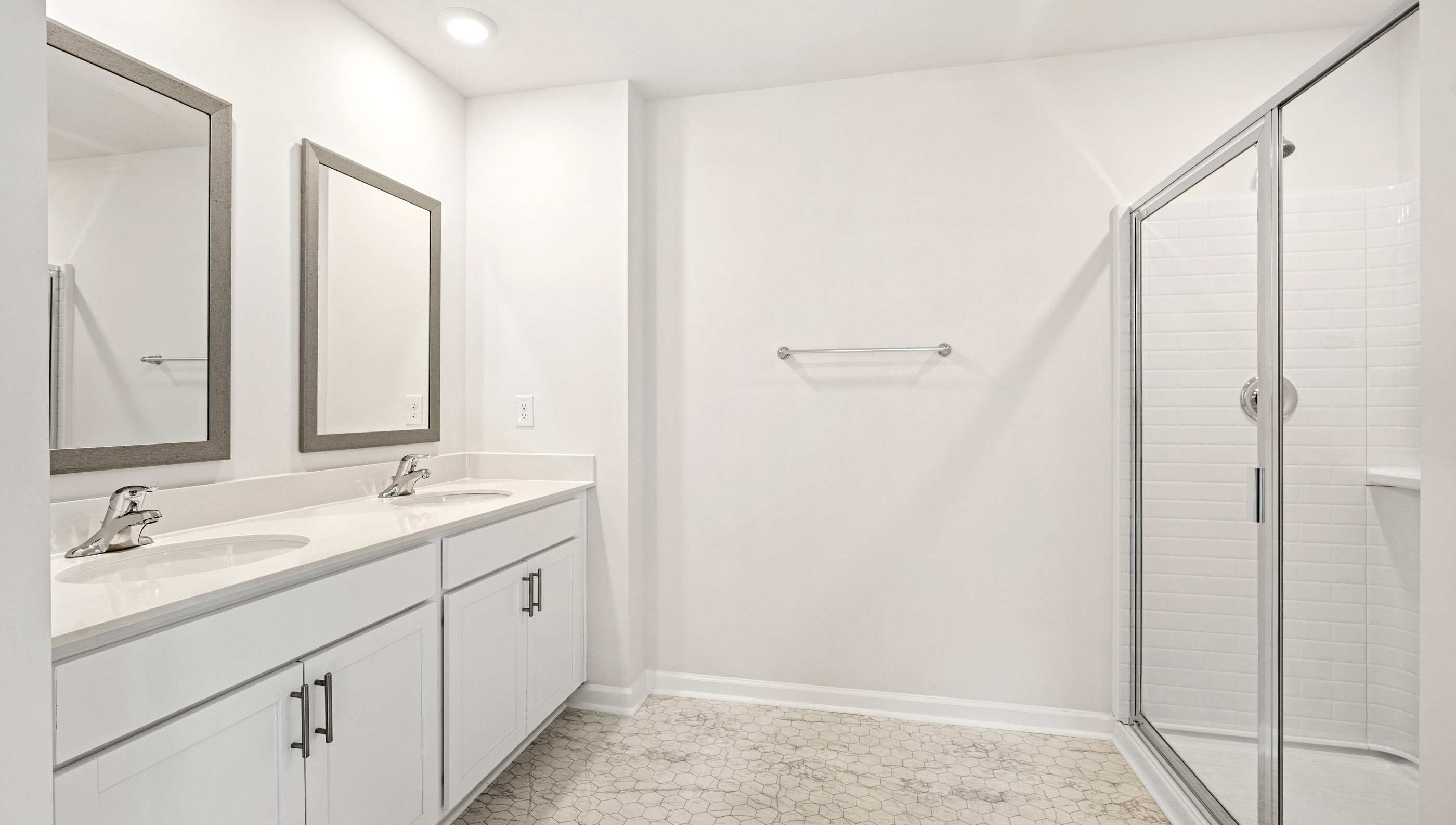 Bathroom with vanity and walk in shower.